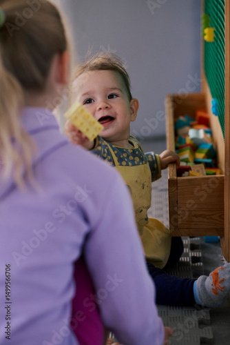 Little girl playing the constructor in the kid indoor  playground.