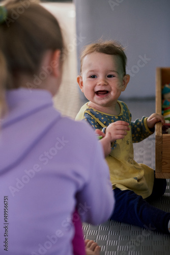 Little girl playing the constructor in the kid indoor  playground.