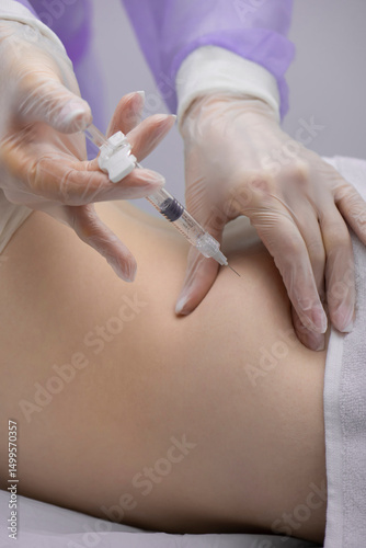 Physiotherapist doing an injection to the back of a patient