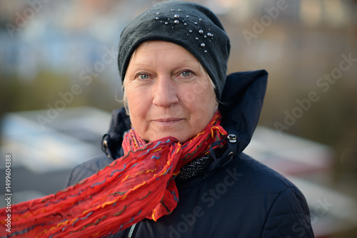 Autumn portrait of a cheerful middle-aged woman in black jacket.