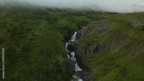 Multiple waterfall tiers in rocky gorge in Norway
