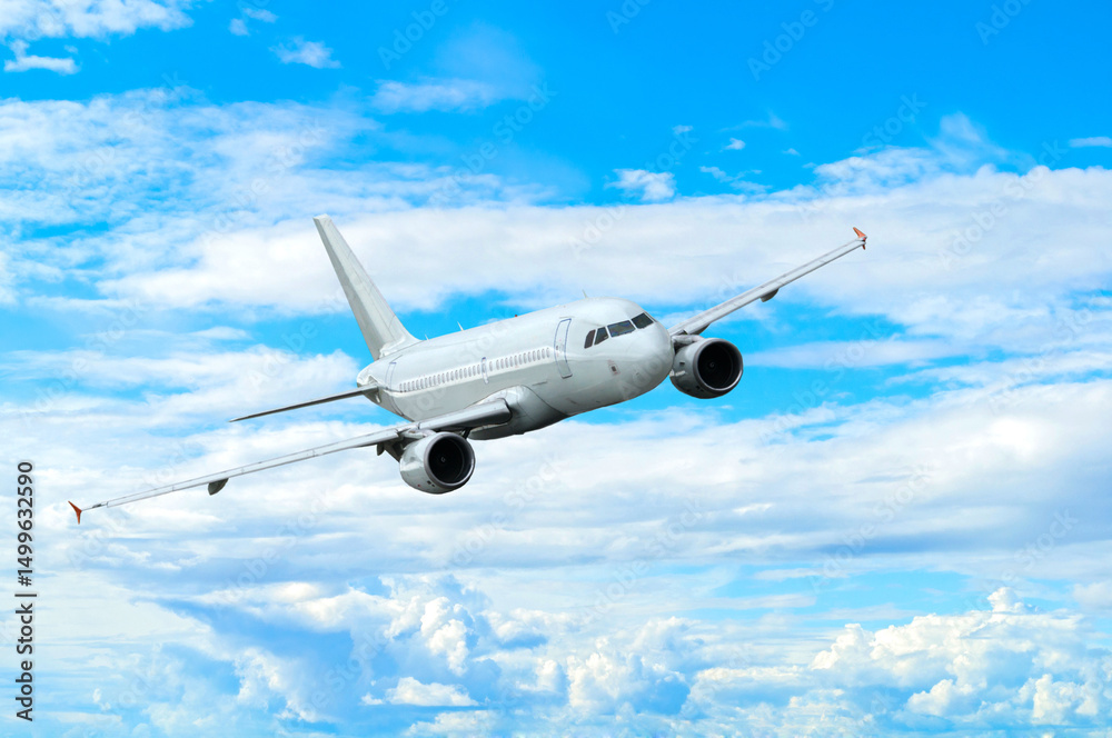 Obraz premium Airplane flying in the sky among clouds, white commercial airplane in the flight
