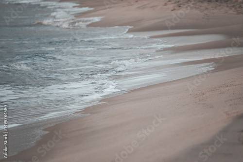 detail of the wave on the beach with pastel tones
