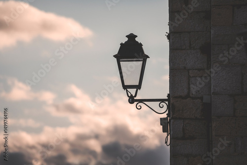 elegant street lamp by the mediterranean sea at sunset time in antibes and pastel clouds in the sky