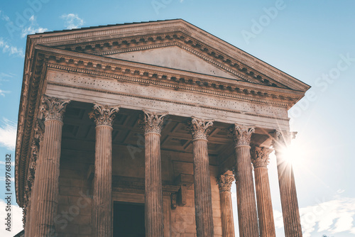 facade and columns of the ancient roman temple in nimes, france