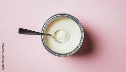 Metal tin of milk with powdered mix and spoon