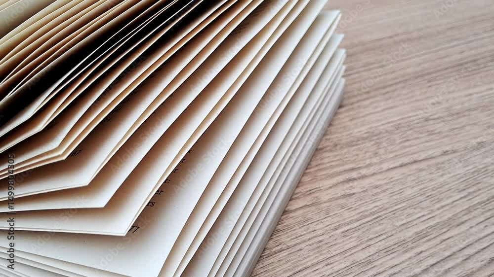Book papers with abundance pages on wood table background 