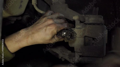 car chassis repair,  hammer knocks on the nut on the axle shaft on a car