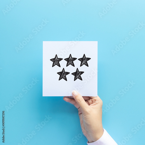 review rating and feedback concept. customer holding paper with very good satisfied review by give five star for service experience