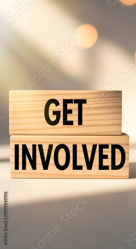 Wooden blocks on a table spelling out 'Get Involved', encouraging participation and engagement