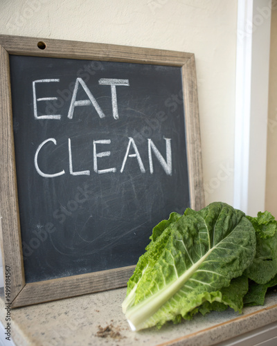 Fresh romaine lettuce beside chalkboard with 