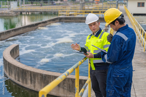 Photography Environmental engineers work at wastewater treatment plants,Water supply engineering working at Water recycling plant for reuse,Technicians and engineers discuss work together