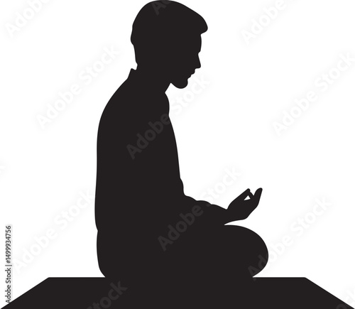 Silhouette of a Muslim man praying on a mat