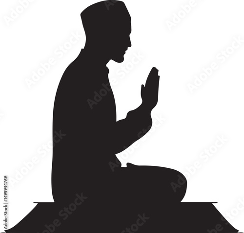 Silhouette of a Muslim man praying on a mat