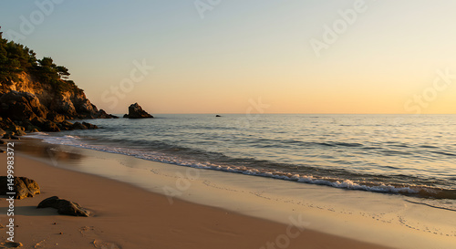 Serene sunrise paints a tranquil beach landscape with gentle waves