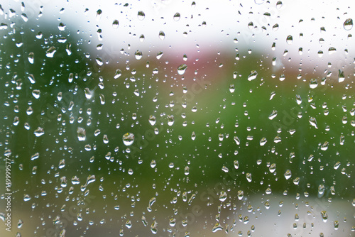 bright summery raindrops on a window glass