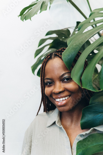 Wallpaper Mural A joyful woman with a beautiful potted plant surrounded by lush greenery Torontodigital.ca