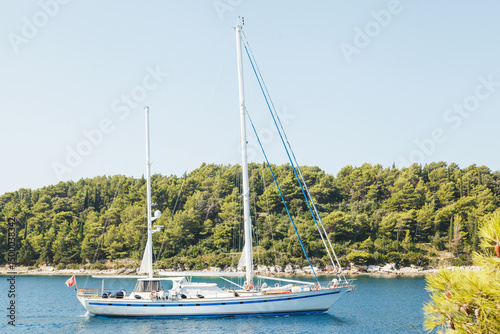 Wallpaper Mural A beautiful sailing yacht anchored peacefully in a tranquil cove surrounded by nature Torontodigital.ca