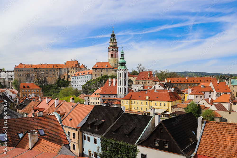 Fototapeta premium Panoramic view of the colorful roofs of Cesky Krumlov and a medieval castle towering over the town.Czech Republic 