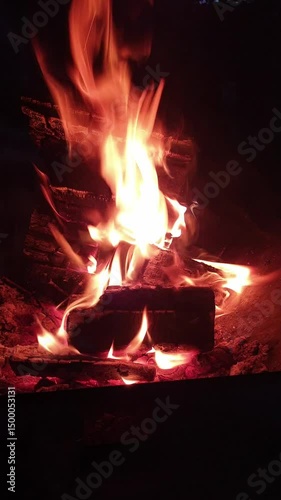 fire burns at night in a fire pit