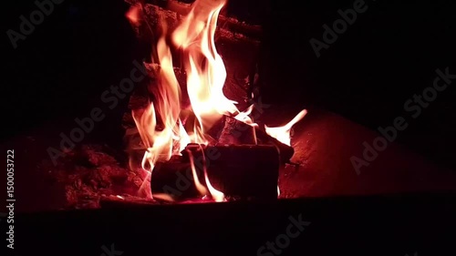 fire burning at night in fire pit, slow motion video