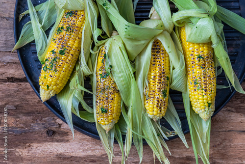 Grilled corn with butter, herbs and himalayan salt. Summer vegan dinner or snack.