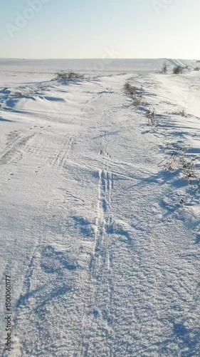 man riding bicycle in snow in winter, solo travel, first person view