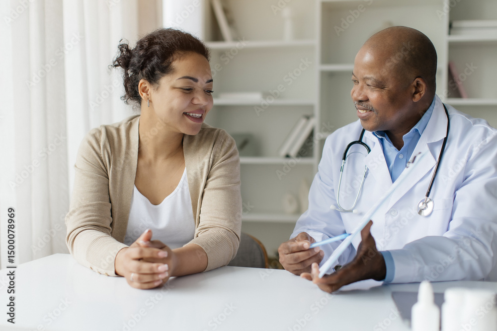 Fototapeta premium Black Doctor Man Showing Clipboard With Test Results To Curious Female Patient, Professional Male Therapist Explaining Medical Therapy Process To Young Woman During Appointment In Office, Closeup