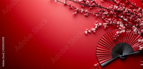 Cherry Blossoms and a Red Fan Create a Vibrant Decoration for an Asian Cultur...