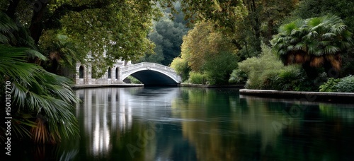 Beautiful Reflections on a Serene Waterway With an Elegant Bridge at Dusk