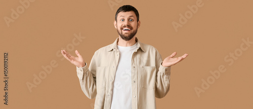 Surprised young man on beig...