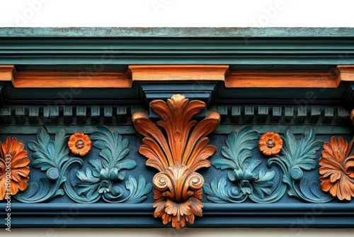 A detailed shot of architectural trim featuring ornate floral and acanthus leaf carvings in teal and orange.