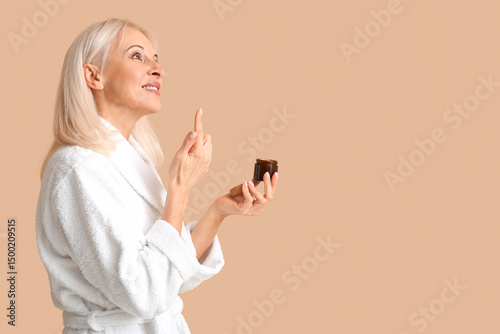 Mature woman in bathrobe wi...