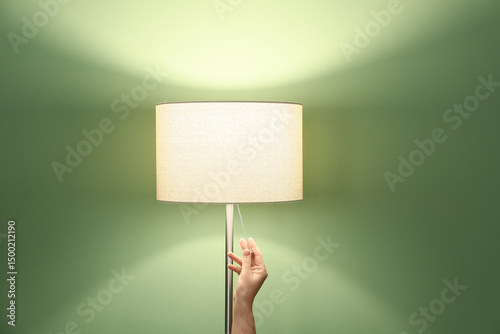 Woman turning off floor lam...