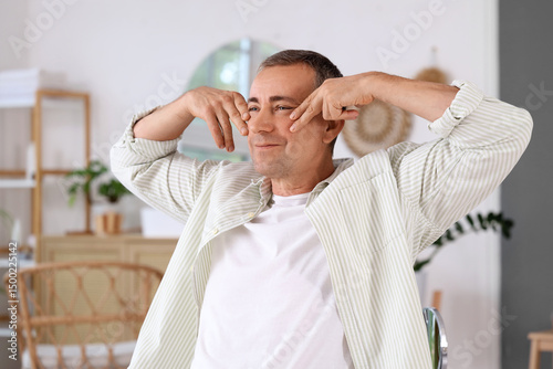 Happy mature man doing face...