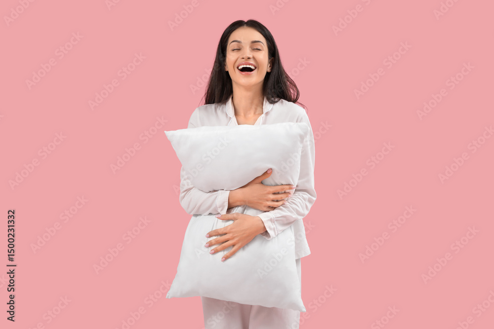 Fototapeta premium Beautiful young happy woman with pillow on pink background