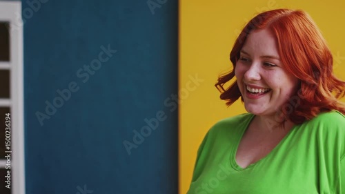 Charming bright happy young ginger chubby overweight woman 20s years old wears green shirt looking camera smiling isolated on plain yellow background studio portrait. People emotions lifestyle concept