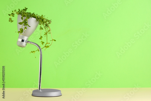 Desk lamp with leaves on gr...