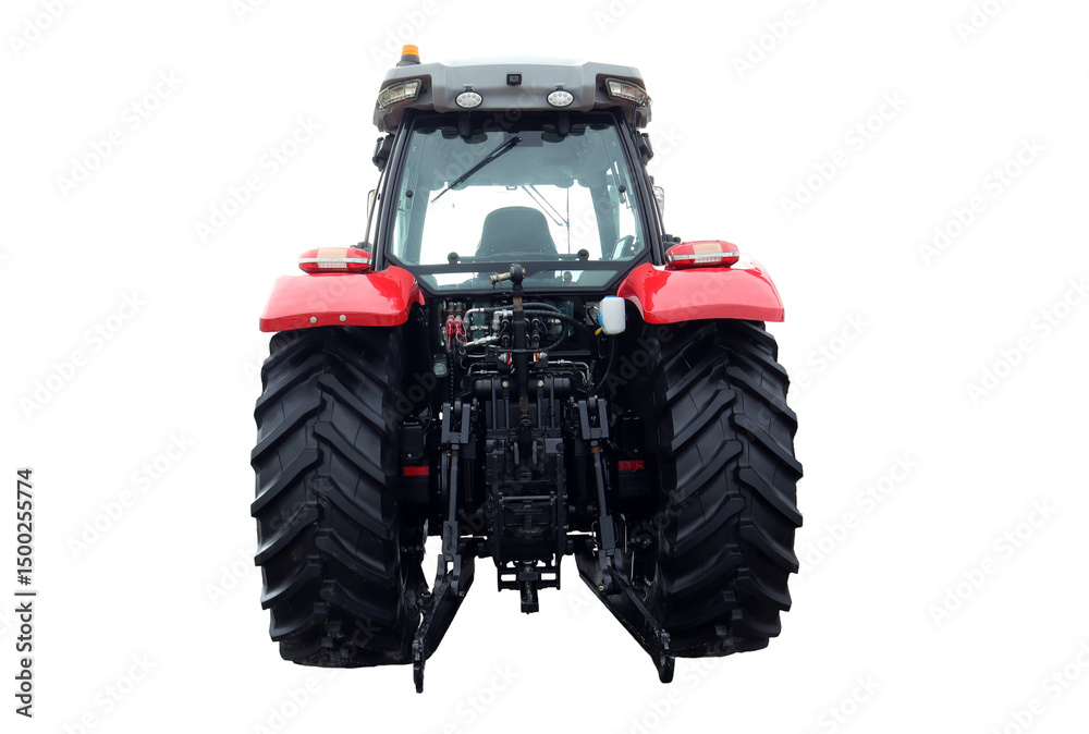 Obraz premium The red farm tractor stands prominently, viewed from the back, highlighting its large tires and agricultural machinery. It is parked in an open field, reflecting a typical day on the farm.