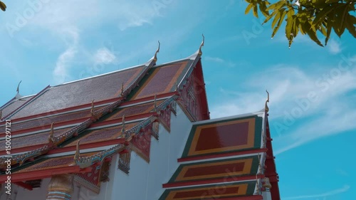 Red tiles with golden serpent-shape chofahs on the picturesque traditional Thai style roof of Wiharn Phra Mongkhon Bophit temple in Ayutthaya