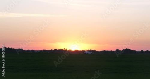Car Driving Past At Sunset