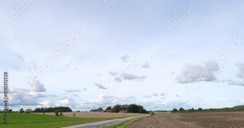 Car Drives Past Field