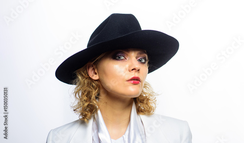 Beautiful young woman in black hat. Fashion portrait of sexy woman with perfect skin in fashionable black hat. Sensual girl with bright makeup in stylish black hat. Sexy blonde model in trendy outfit.