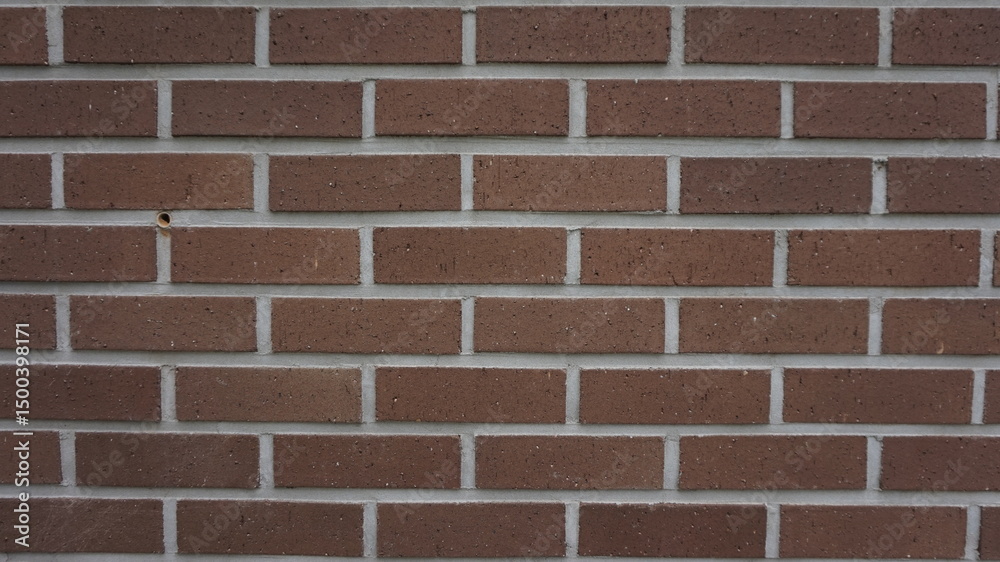 Obraz premium The rhythmic pattern of brown bricks offers a timeless aesthetic, bringing warmth and structure to any space
