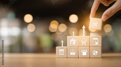 Franchise business growth and expansion concept. Hand stacking wooden blocks with store and arrow icons, franchise business growth, expansion, success entrepreneurship, market development, online shop