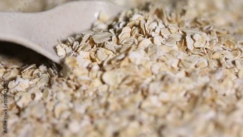  Pile of uncooked rolled oats rotating