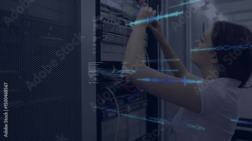 IT intern inserting ethernet cable into patch port, generating code overlays showing network flow