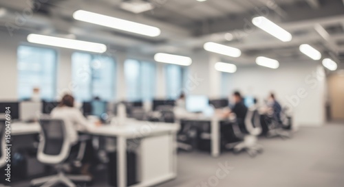 Blurred Photo of Office Interior with People Working at Desks in a Modern Setting