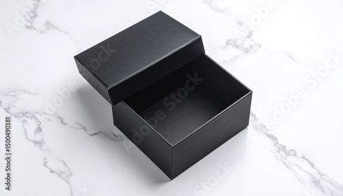 Open black gift box on marble.
