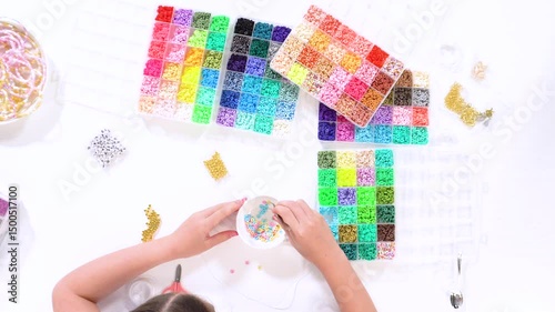 Young Girl Engrossed in Crafting with Colorful Clay Beads